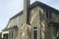 Stucco home with signs of failure on chimney