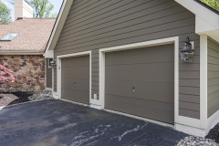 A completed stucco remediation near a garage