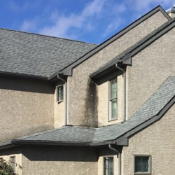 Photo of black streaking on a home with stucco siding